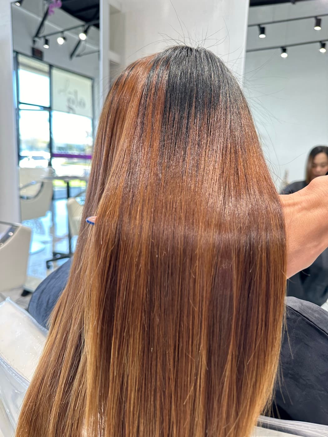 Long caramel-balayage sleek hair, alternate angle