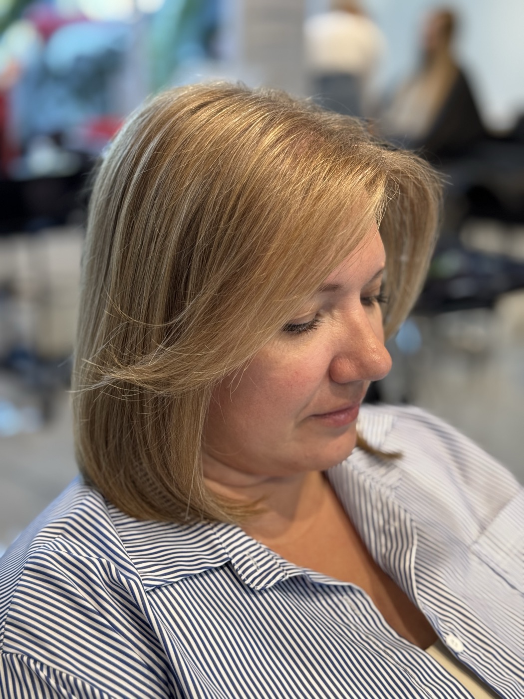 Shoulder-length blonde hair, side profile
