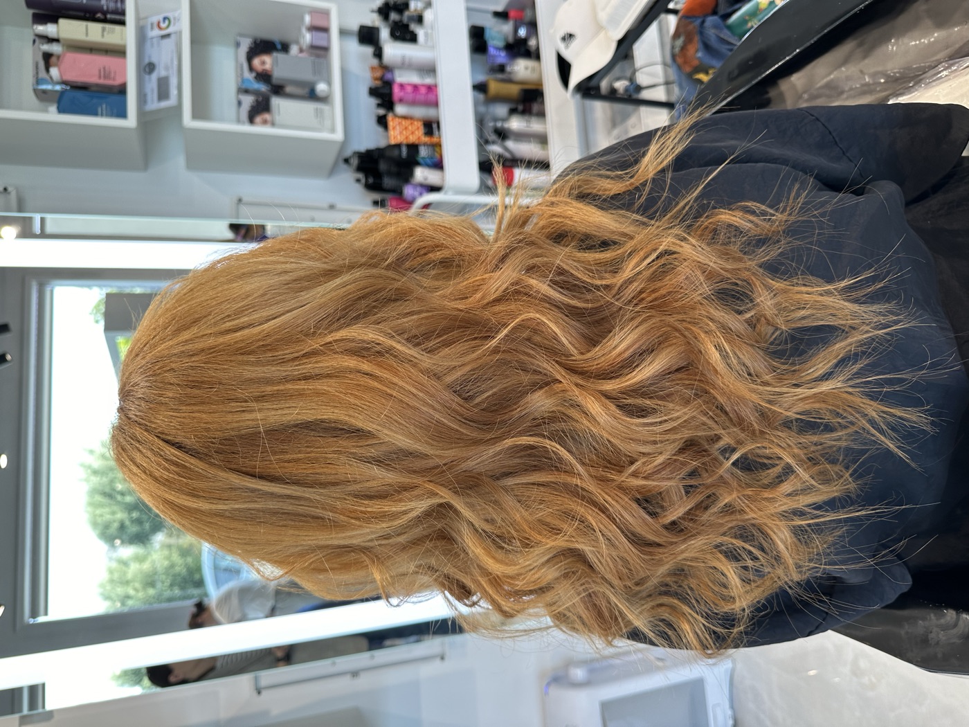 Long copper-blonde curled hair