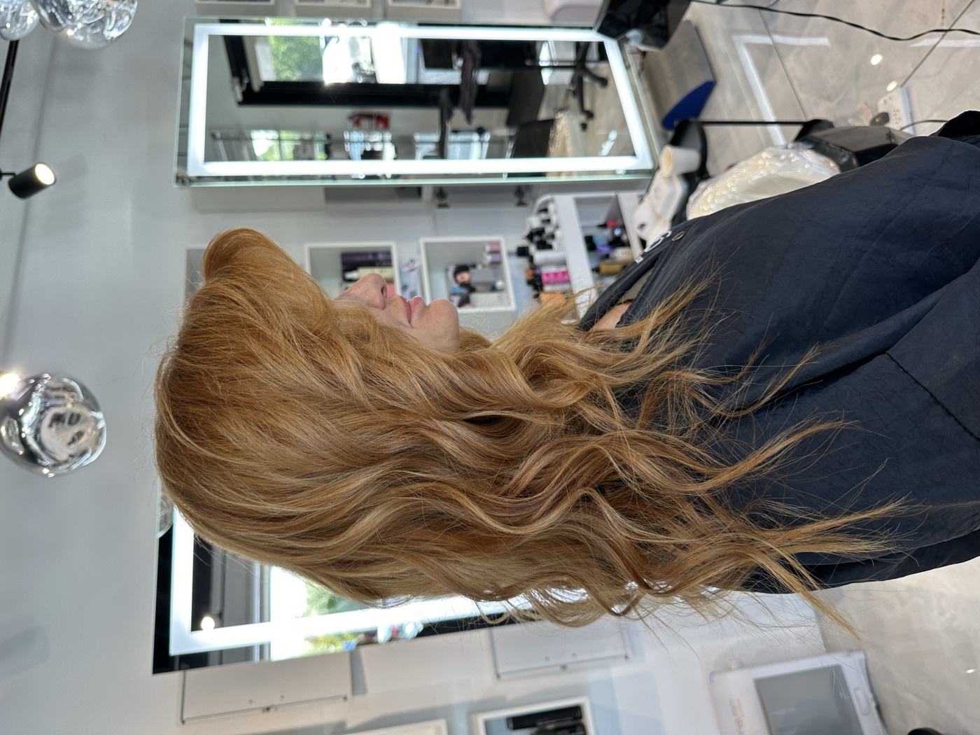 Long copper-blonde wavy hair, side profile