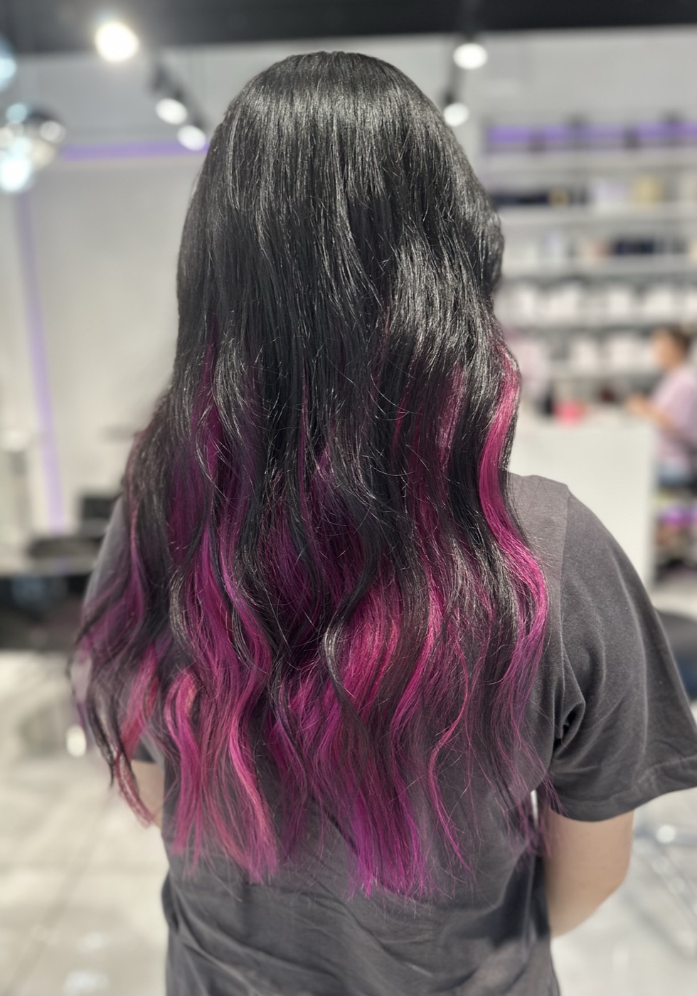 Long dark wavy hair with pink and purple ends, alternate angle
