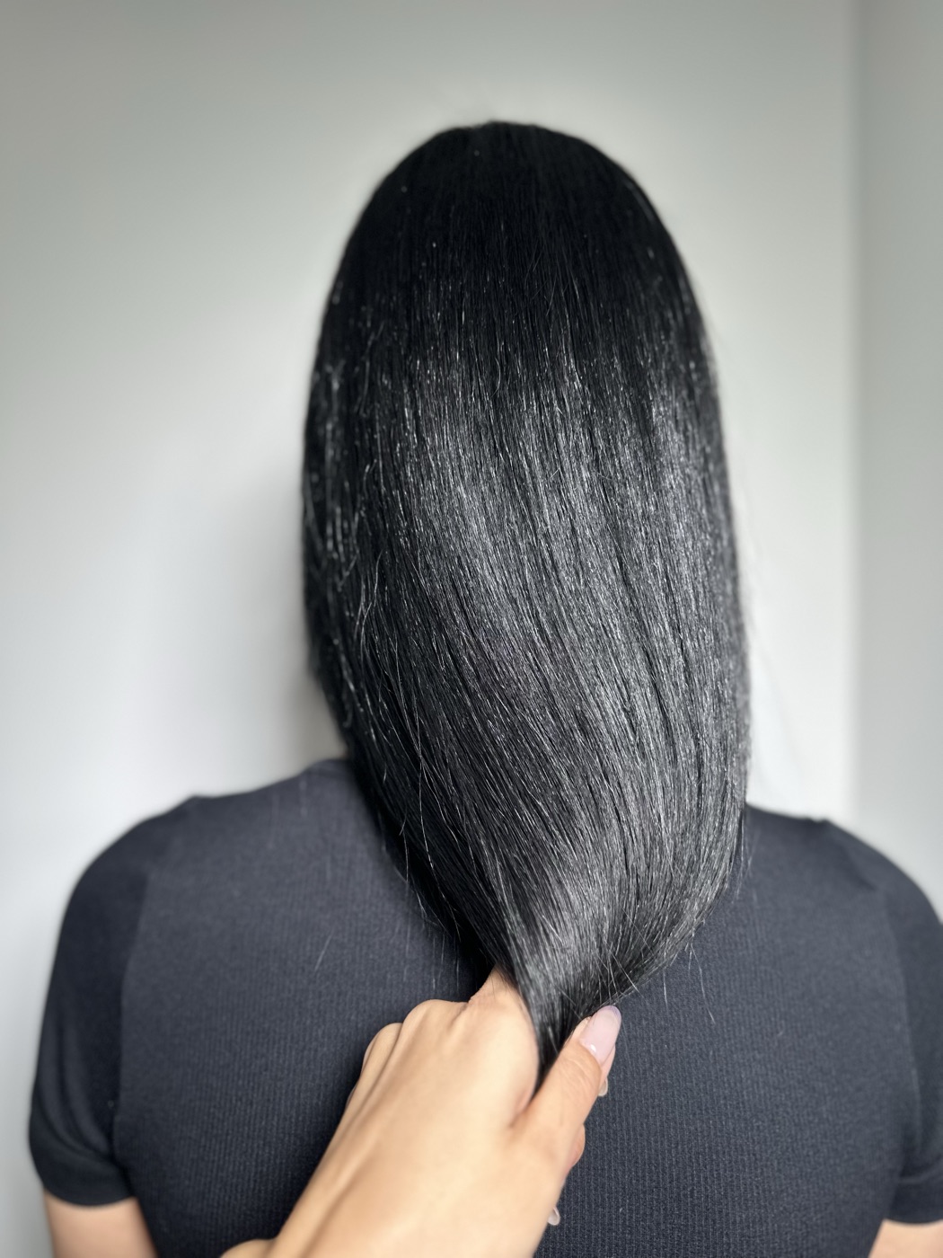Long sleek black hair, held forward, alternate angle